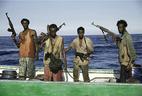 Somali pirates holding weapons as they prepare to board the Maersk Alabama.